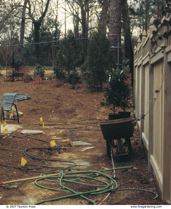 Before construction, there was just a sloped backyard and narrow side yard  where water flowed toward the house.