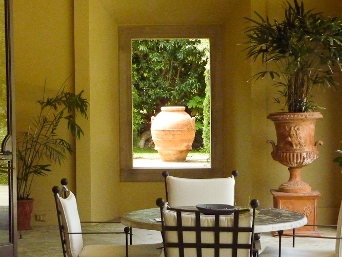Looking out of window to terracotta urn