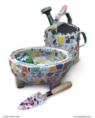 image of mosaic watering container, trowel and pot