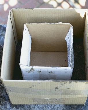 Form the walls of a rectangular planter by centering a smaller box inside a larger one.