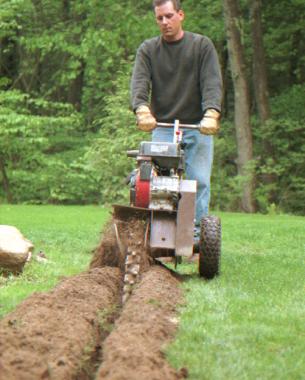 author using a trench digger